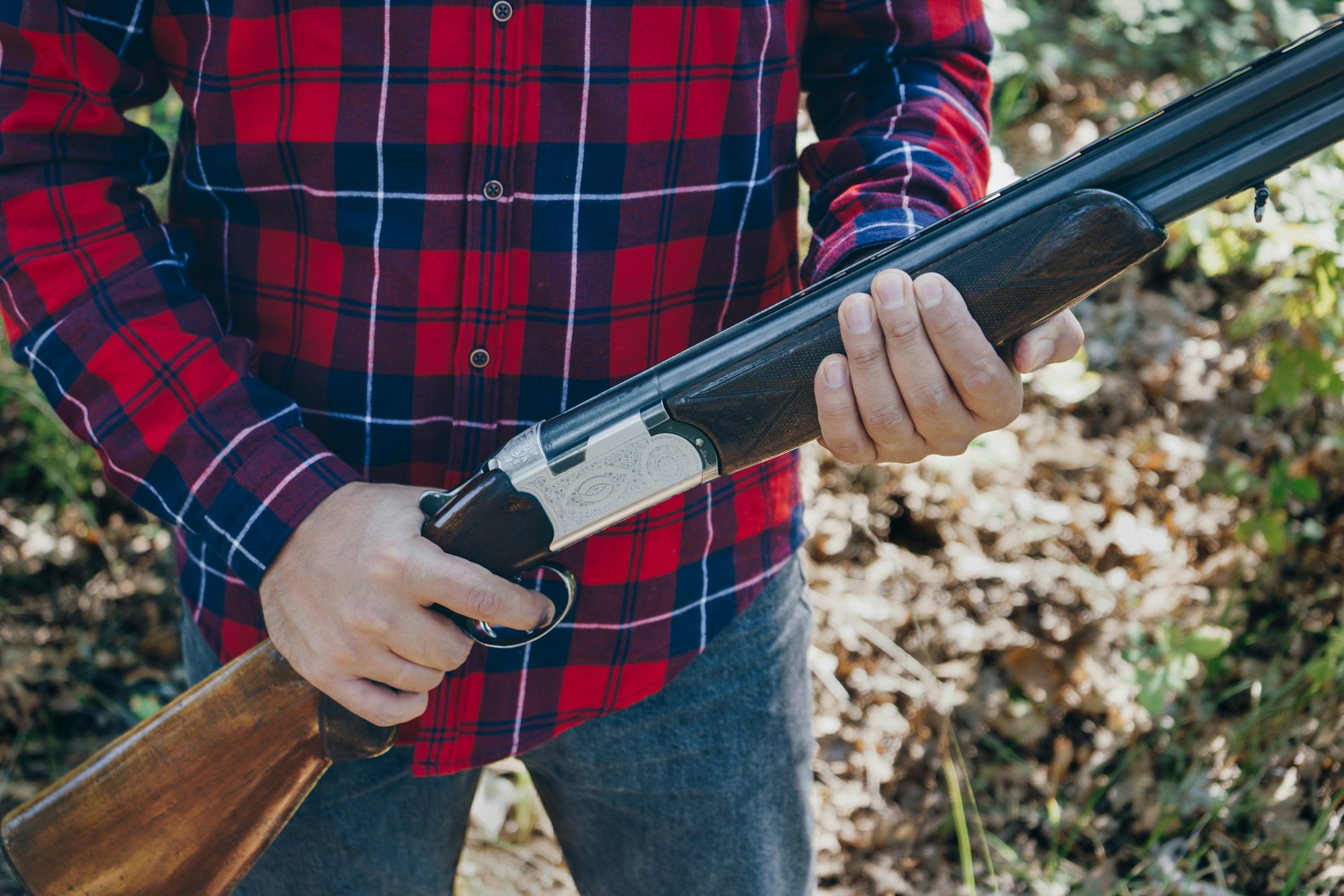 Hunter with a gun on the forest